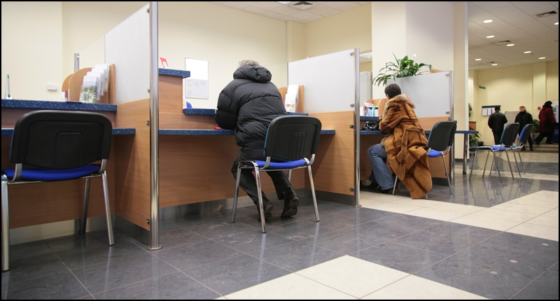 People Sitting at a Bank getting Service