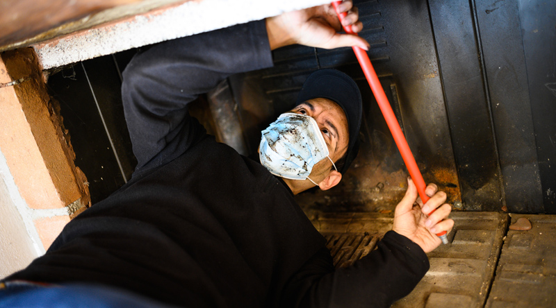 Man Cleaning Fireplace